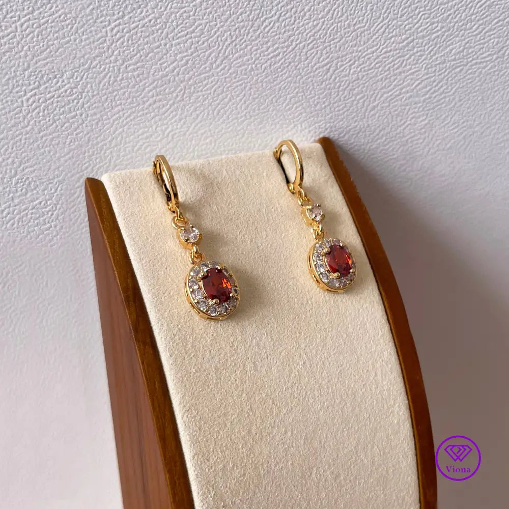 Gold plated oval earrings with main red topaz stone and small white topaz decoration