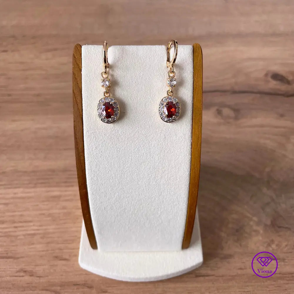 Gold plated oval earrings with main red topaz stone and small white topaz decoration