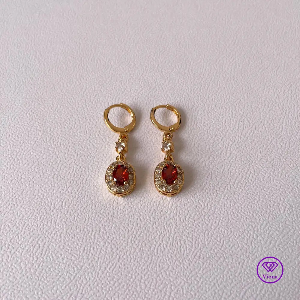 Gold plated oval earrings with main red topaz stone and small white topaz decoration