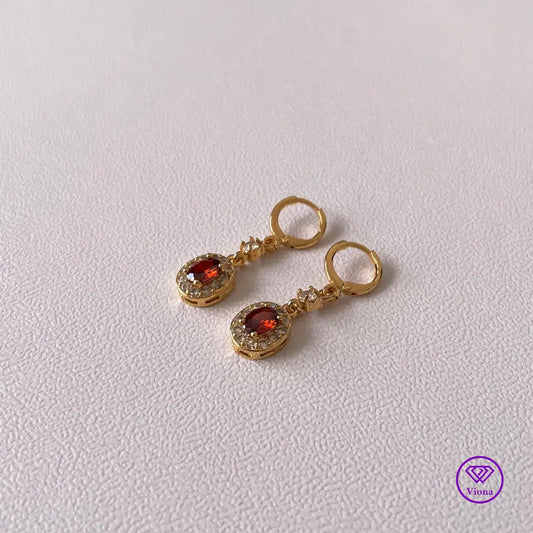 Gold plated oval earrings with main red topaz stone and small white topaz decoration