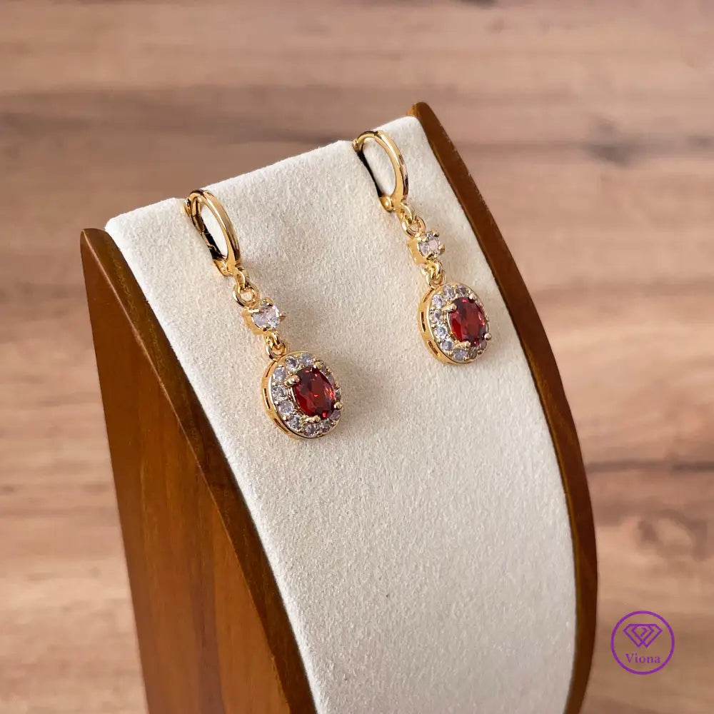 Gold plated oval earrings with main red topaz stone and small white topaz decoration