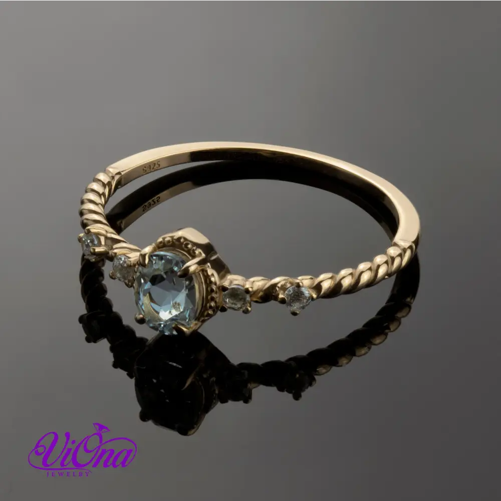 Oval Blue Topaz Gemstone Radiance: Gold-Plated 925 Sterling Silver Ring with 4 Side Stones and Intricate Rope Detailing