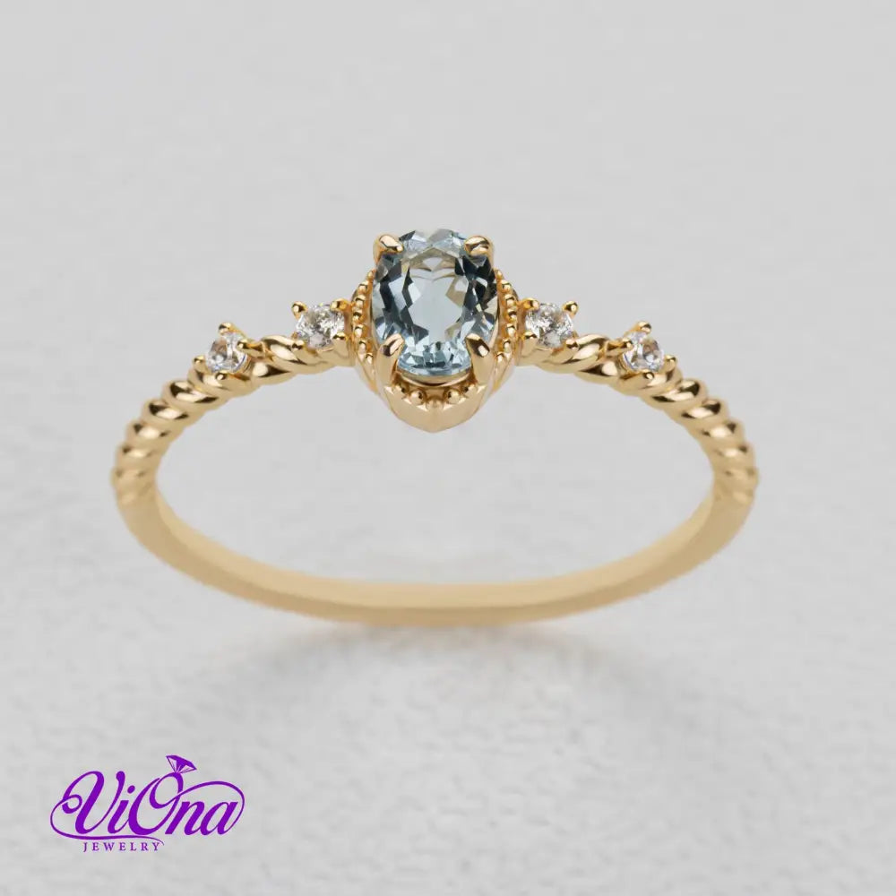 Oval Blue Topaz Gemstone Radiance: Gold-Plated 925 Sterling Silver Ring with 4 Side Stones and Intricate Rope Detailing