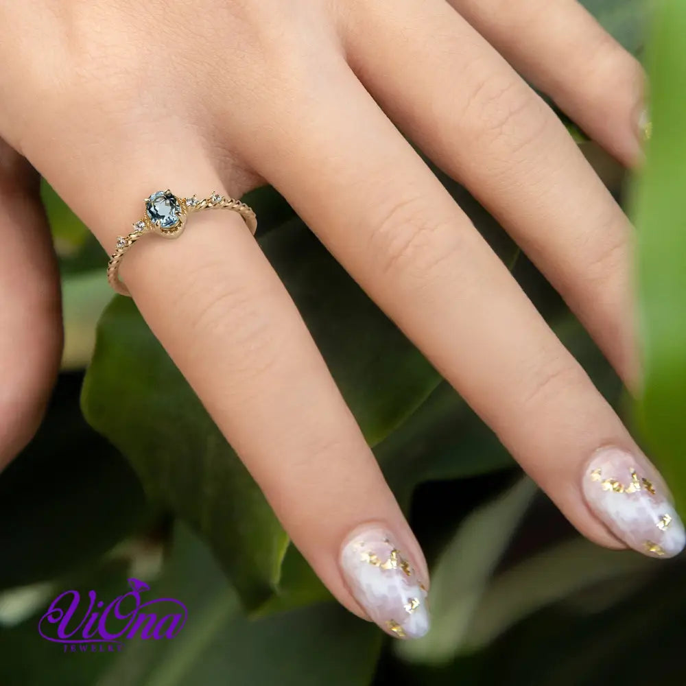 Oval Blue Topaz Gemstone Radiance: Gold-Plated 925 Sterling Silver Ring with 4 Side Stones and Intricate Rope Detailing