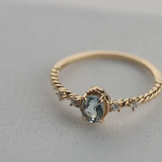 Oval Blue Topaz Gemstone Radiance: Gold-Plated 925 Sterling Silver Ring with 4 Side Stones and Intricate Rope Detailing