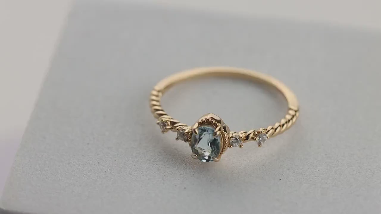 Oval Blue Topaz Gemstone Radiance: Gold-Plated 925 Sterling Silver Ring with 4 Side Stones and Intricate Rope Detailing